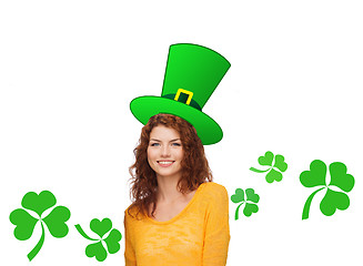 Image showing smiling teen girl in green top hat with shamrock