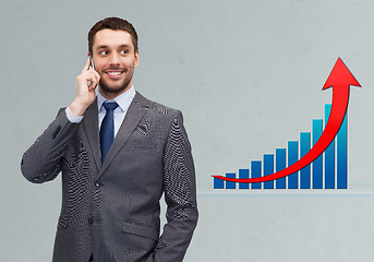 Image showing young smiling businessman calling on smartphone