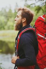 Image showing smiling man with beard and backpack hiking