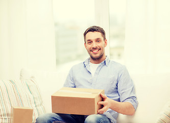 Image showing man with cardboard boxes at home