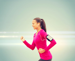 Image showing smiling young woman running