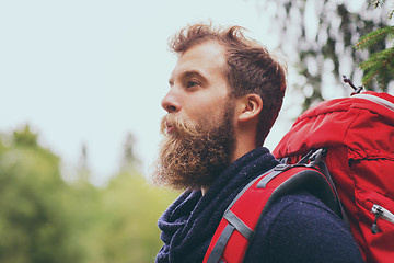 Image showing smiling man with beard and backpack hiking