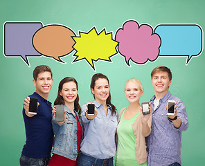 Image showing happy friends showing blank smartphones screens