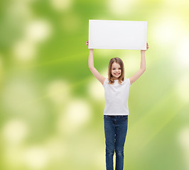 Image showing smiling little girl holding blank white board