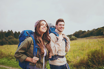 Image showing smiling couple with backpacks hiking