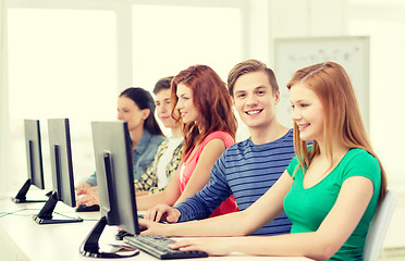 Image showing smiling student with computer studying at school