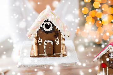 Image showing close up of woman showing gingerbread house