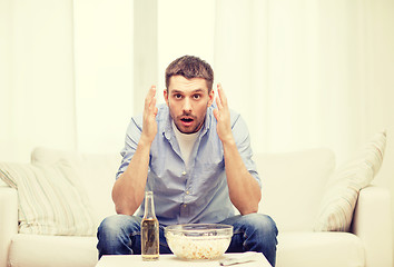 Image showing sad man watching sports at home