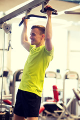 Image showing smiling man exercising in gym