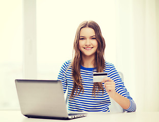 Image showing smiling teenage gitl with laptop computer at home