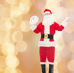 Image showing man in costume of santa claus with clock