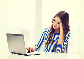 Image showing upset teenage gitl with laptop computer at home