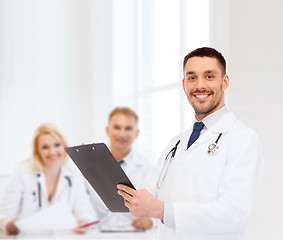 Image showing smiling male doctor with clipboard and stethoscope