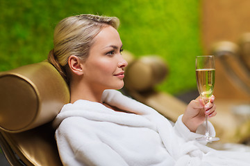 Image showing beautiful young woman drinking champagne at spa