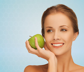 Image showing smiling young woman with green apple