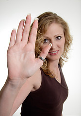 Image showing Blonde woman holding up hand