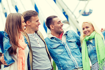 Image showing group of smiling friends in amusement park