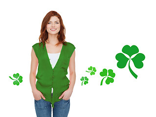 Image showing smiling teenage girl in green vest with shamrock