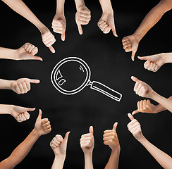 Image showing hands showing thumbs up in circle over magnifier