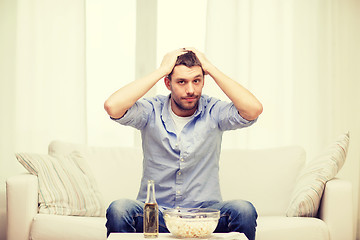 Image showing sad man watching sports at home