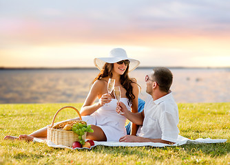 Image showing happy couple drinking champagne on picnic