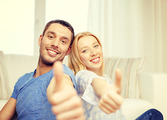 Image showing smiling happy couple at home showing thumbs up
