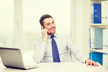 Image showing businessman with laptop and smartphone at office