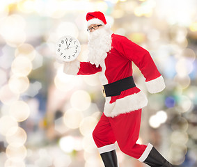 Image showing man in costume of santa claus with clock