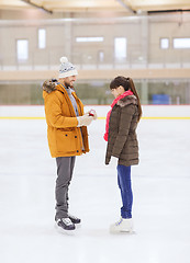 Image showing happy couple with engagement ring on skating rink