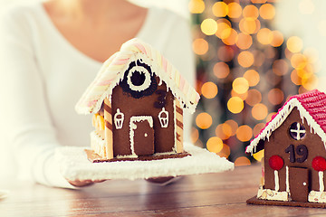 Image showing close up of woman showing gingerbread house