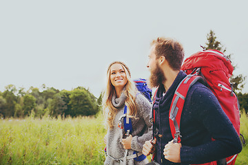 Image showing smiling couple with backpacks hiking