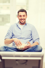 Image showing smiling man watching sports at home