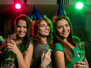 Image showing smiling friends with glasses of champagne in club