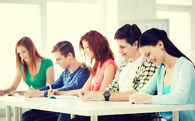 Image showing smiling students with textbooks at school