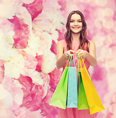 Image showing smiling woman in dress with many shopping bags