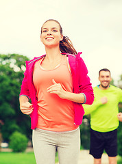 Image showing smiling couple running outdoors