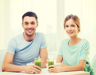 Image showing smiling couple having breakfast at home