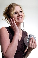 Image showing Smiling woman listening to music