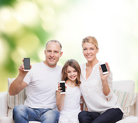 Image showing happy family with smartphones