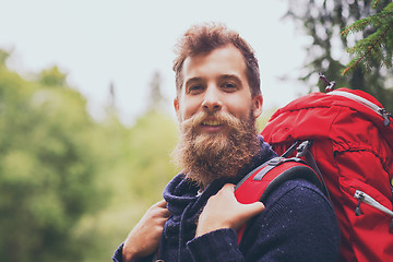 Image showing smiling man with beard and backpack hiking