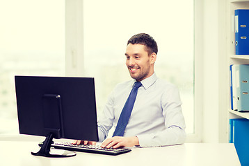 Image showing smiling businessman or student with computer