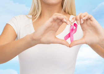 Image showing close up of woman and pink cancer awareness ribbon