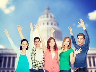 Image showing group of smiling students waving hands