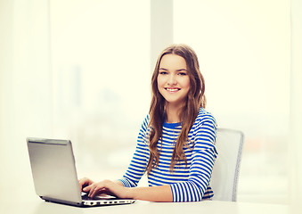 Image showing smiling teenage gitl with laptop computer at home