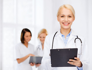 Image showing smiling female doctor with clipboard