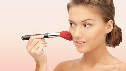 Image showing beautiful smiling woman with make up brush