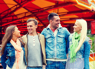 Image showing group of smiling friends in amusement park