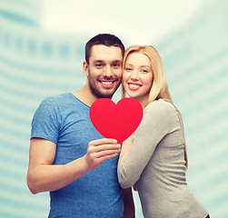 Image showing smiling couple holding big red heart