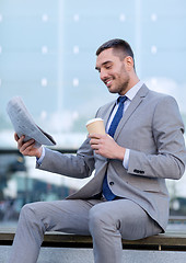 Image showing young businessman with coffee and newspaper