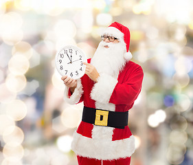 Image showing man in costume of santa claus with clock